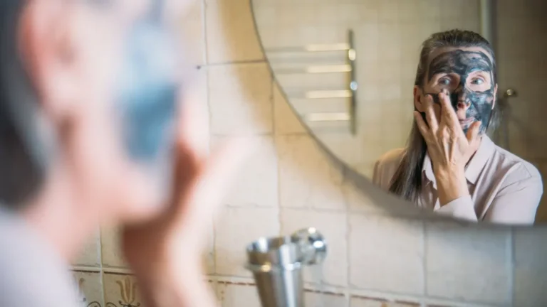 senior woman applying face cream