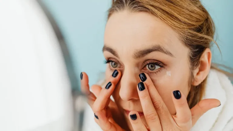 senior woman applying face cream