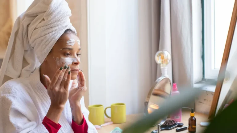 senior woman applying face cream