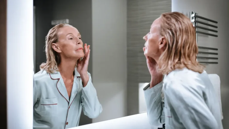 senior woman applying face cream