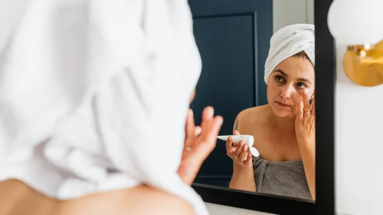 senior woman applying face cream