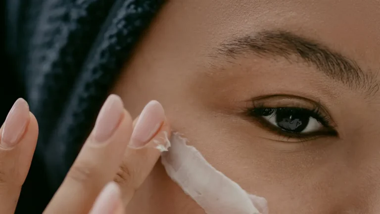 senior woman applying face cream