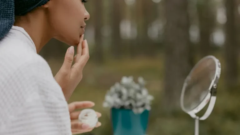 senior woman applying face cream