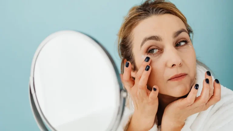 senior woman applying face cream